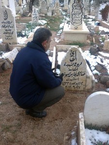 Mohammad al-Bayoush visiting his daughter’s grave. Photograph: Mustapha al-Jalal. 