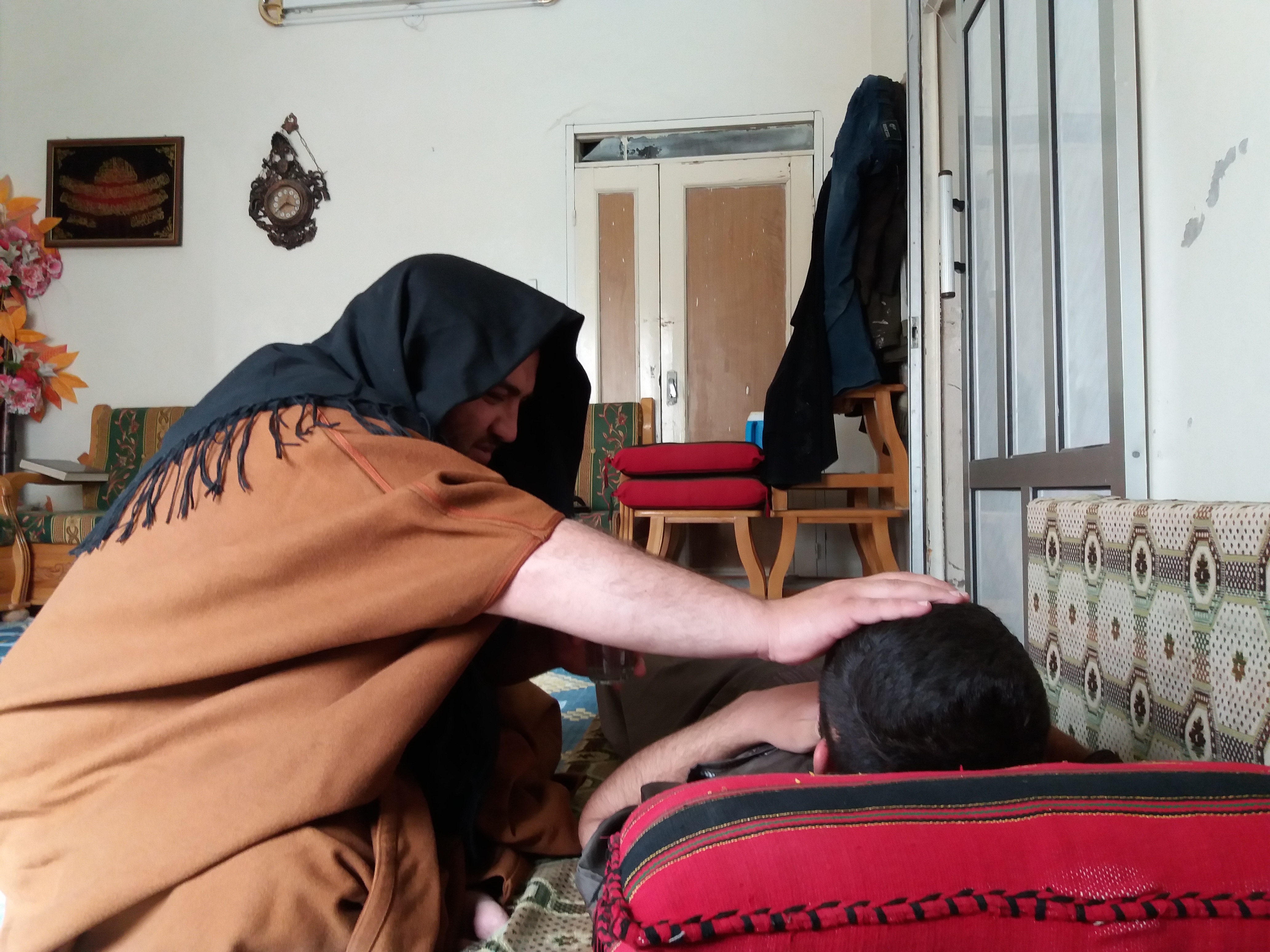 An al-Ruqyah al-Shar’iyyah session performed on a young man suffering from headaches. Photo: Hazza Adnan al-Hazza