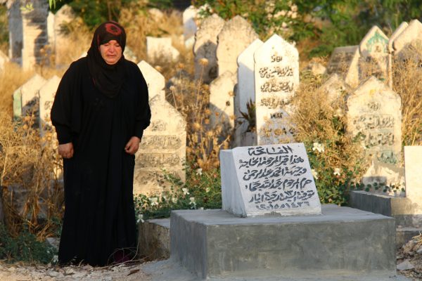 A mother visiting the grave of her son who was killed in an air raid in 2015. Photo by: Mujahid Abu al-Jud
