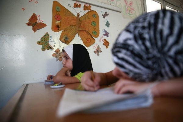 Children attend a summer course in a Douma school to help them catch up with their education.