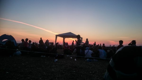 A group of displaced people wait at dawn at a train station in Greece – Photo: Ahmad Khalil